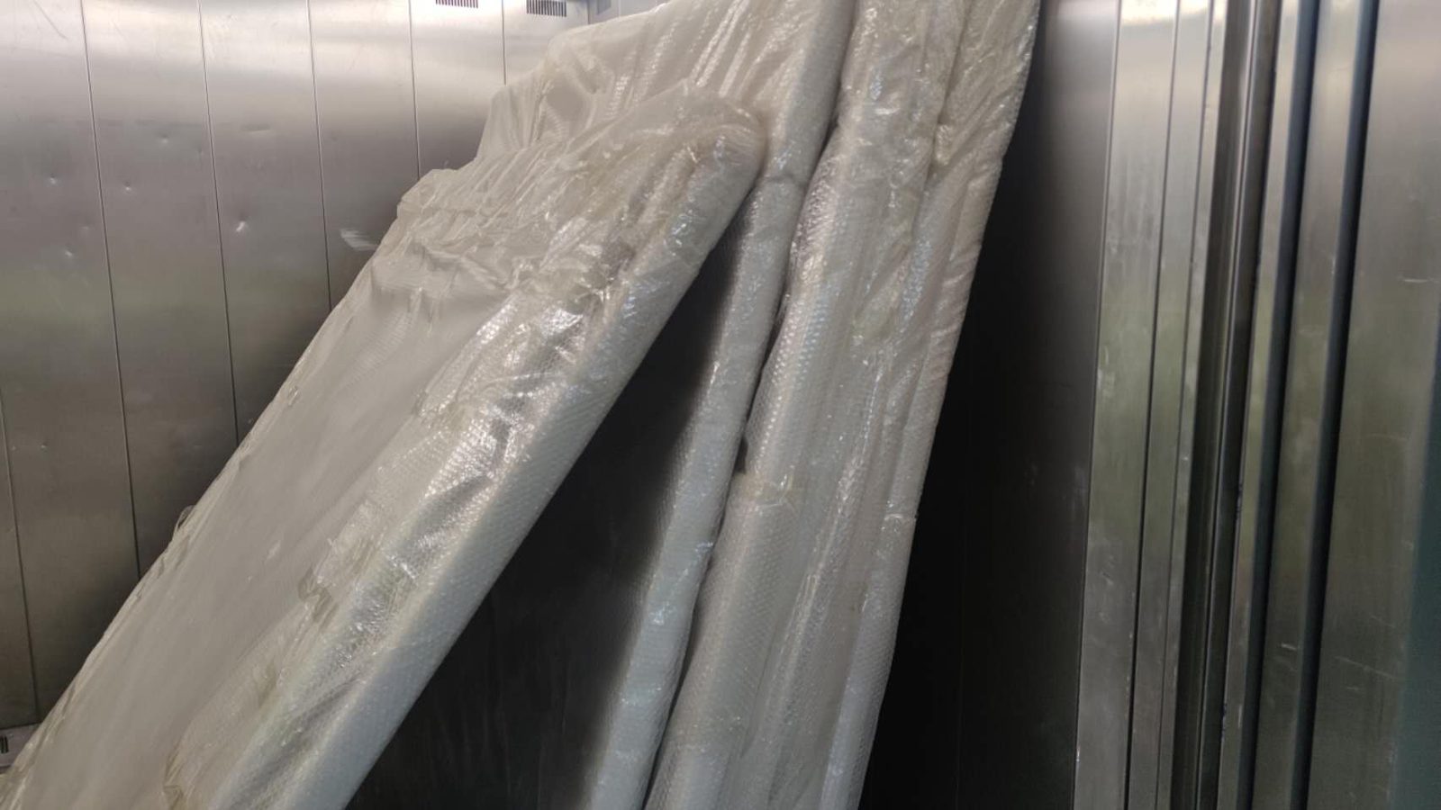 Large protected items positioned inside a building lift during a real JD Movers job relevant to Blackburn North moves