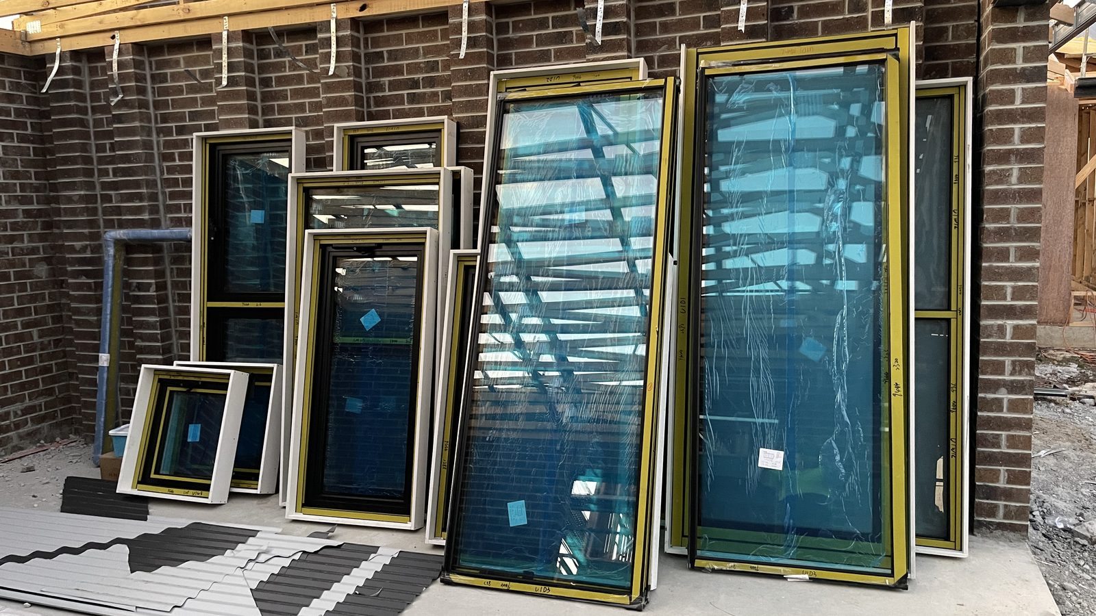 Large glass frames grouped by size in a real JD Movers job, illustrating Bundoora move planning