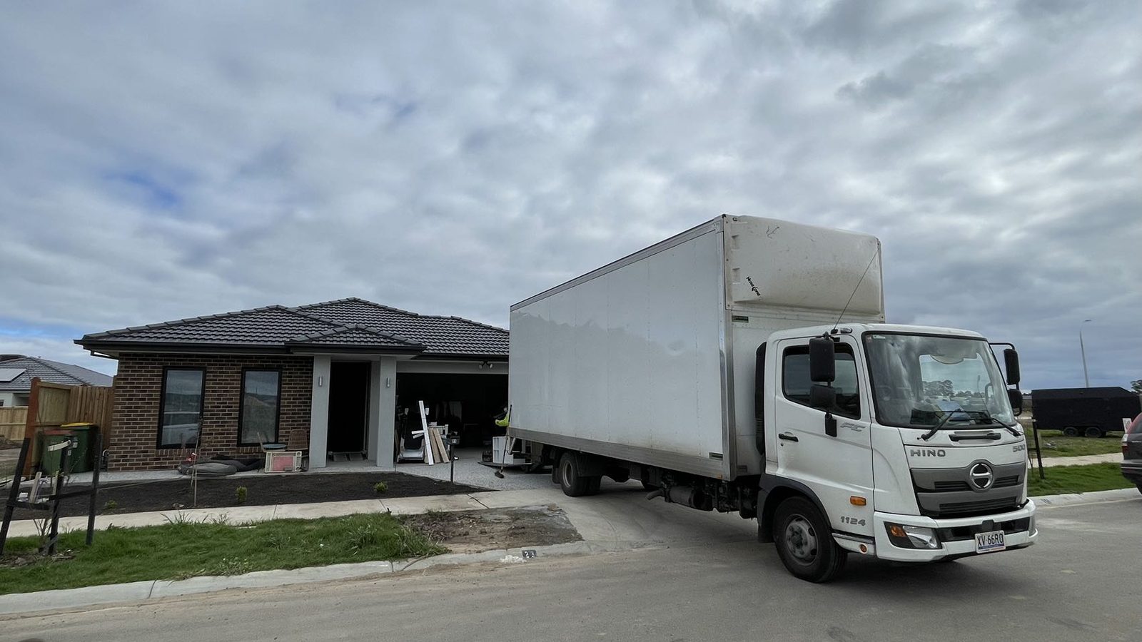Moving truck positioned beside a family home during a real JD Movers job relevant to Dingley moves