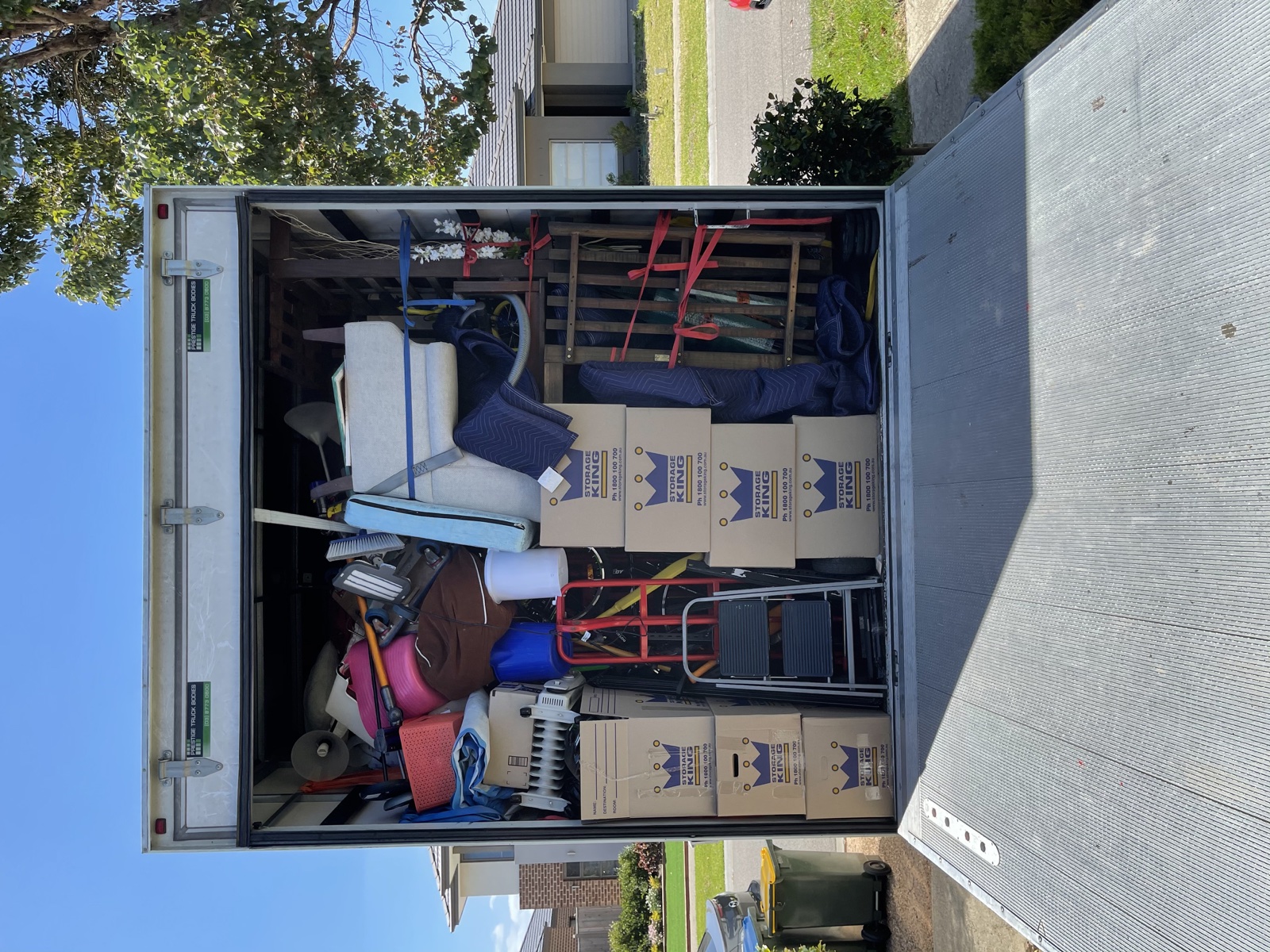 Separate real JD Movers 10 tonne truck load with furniture, boxes and moving blankets illustrating lower-waste planning