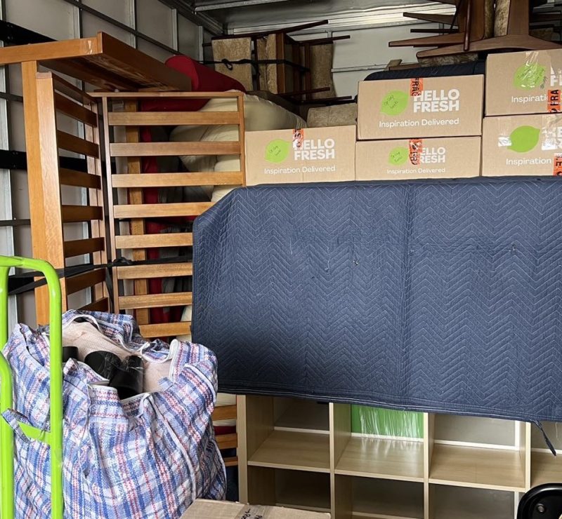 Separate real JD Movers truck load with protected furniture and cartons, illustrating storage move planning