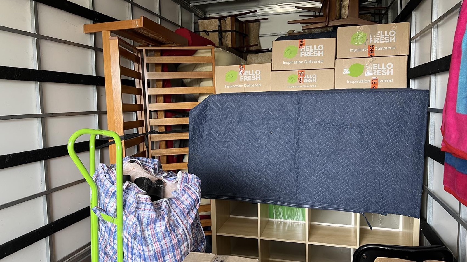 Separate real JD Movers truck load with protected furniture and cartons, illustrating storage move planning