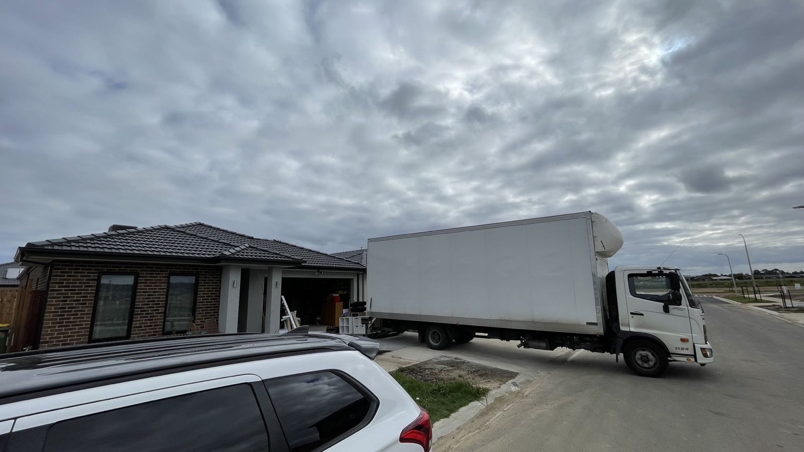 Separate real JD Movers truck positioned at a Melbourne residential pickup, illustrating truck access planning