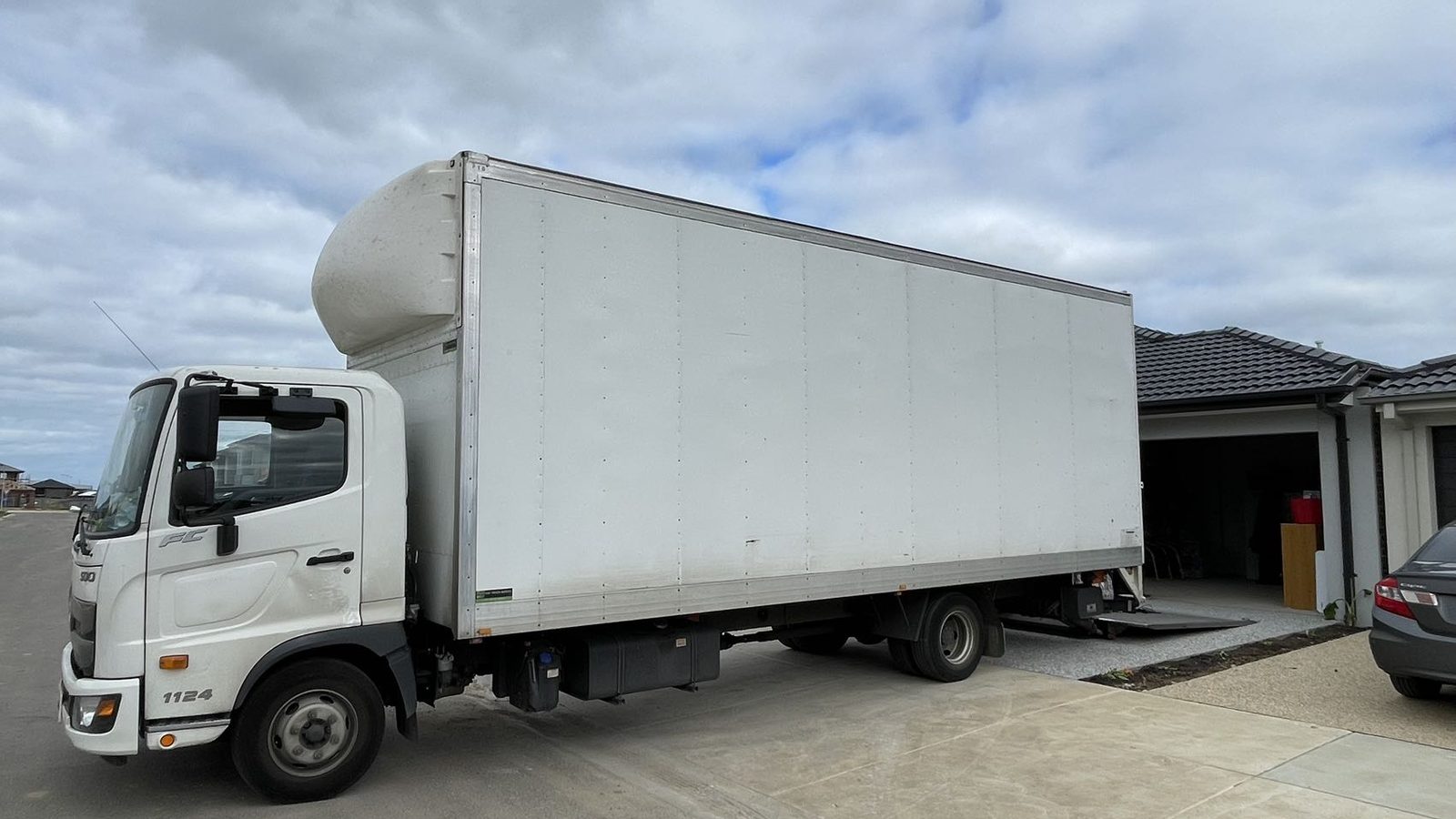JD Movers truck positioned at a separate real residential pickup, illustrating Noble Park access planning
