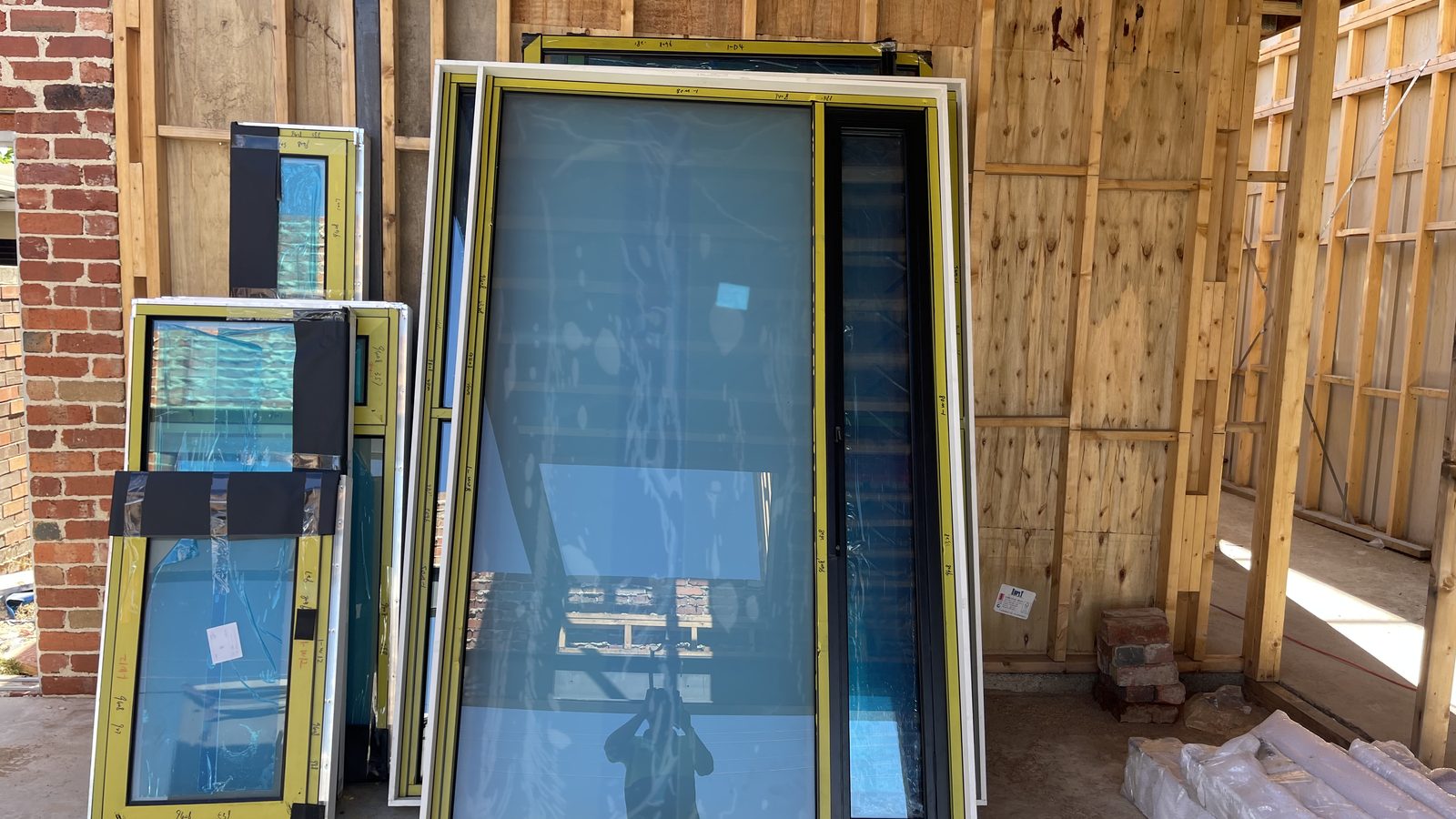 Window and door panels organised before loading in a real JD Movers job, illustrating Officer move planning
