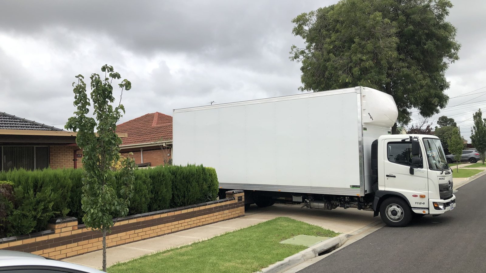 A moving truck positioned along a residential street in a real JD Movers job, illustrating Seaford move planning