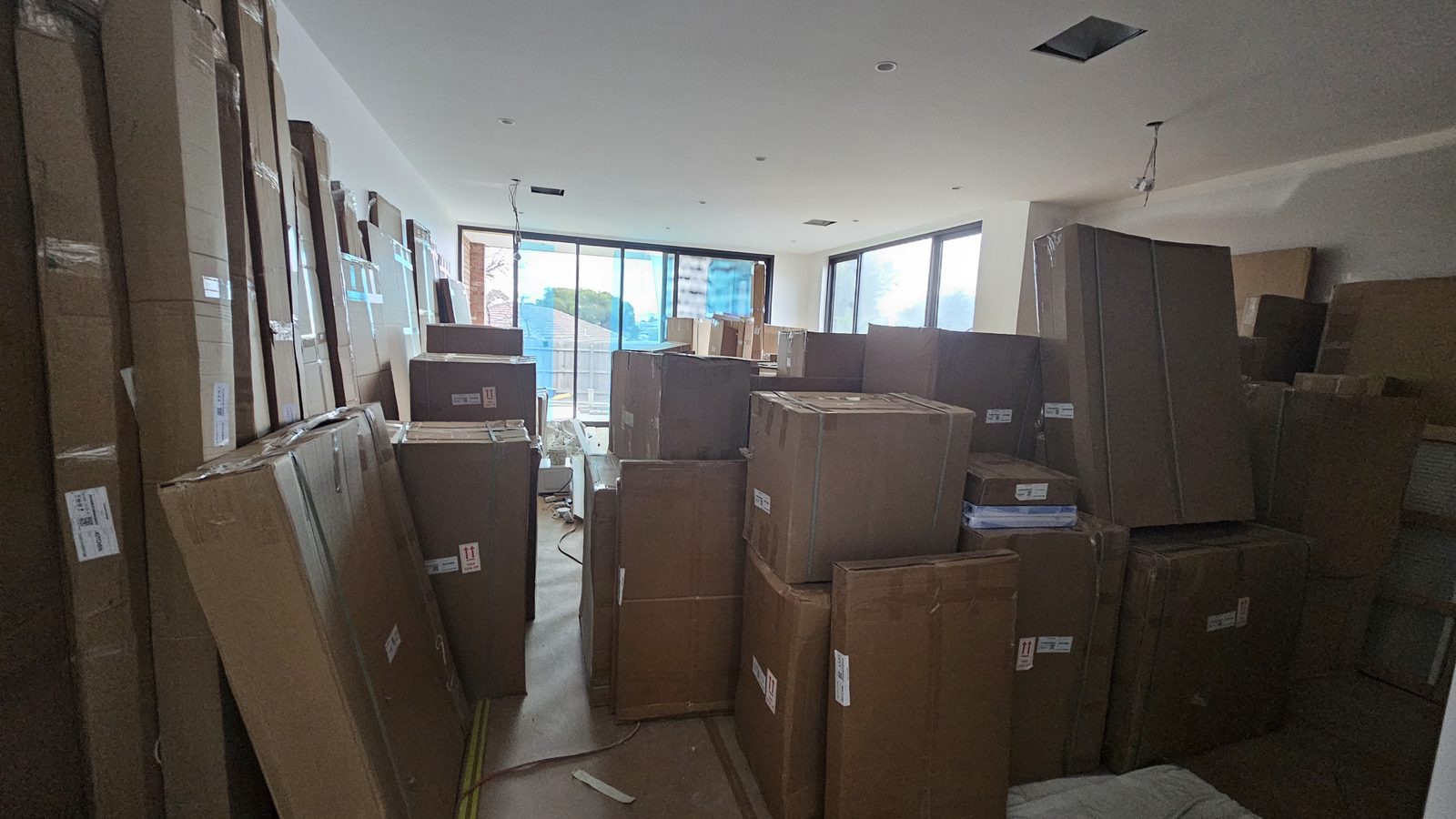 Packed boxes and household items staged for a South Yarra apartment move