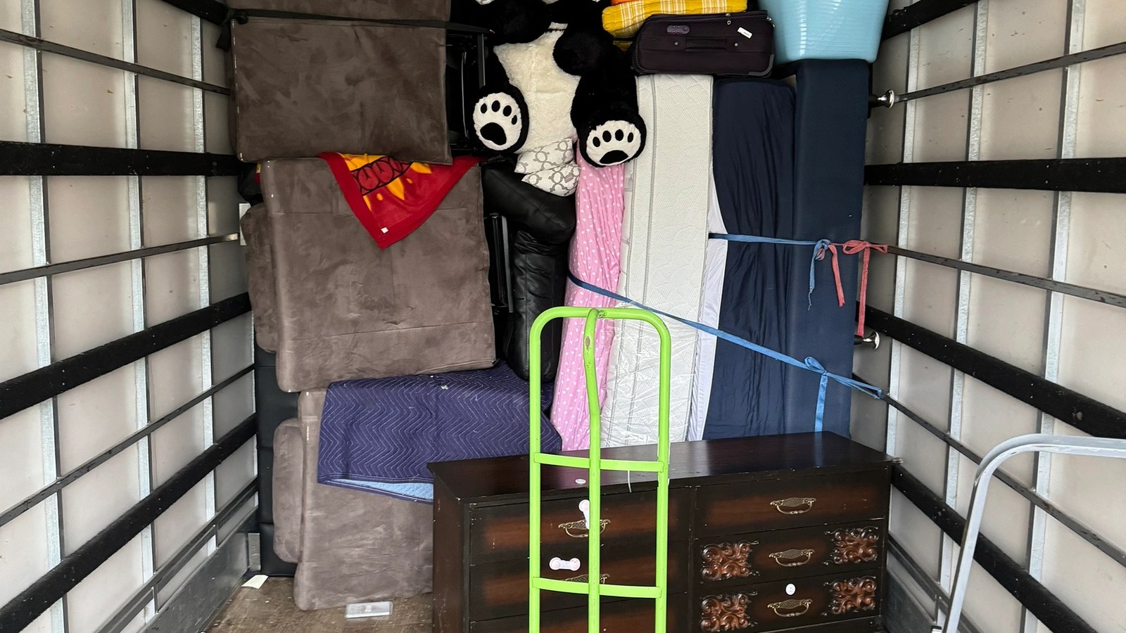Family-home furniture and moving equipment arranged inside a real JD Movers truck, illustrating Thomastown moves